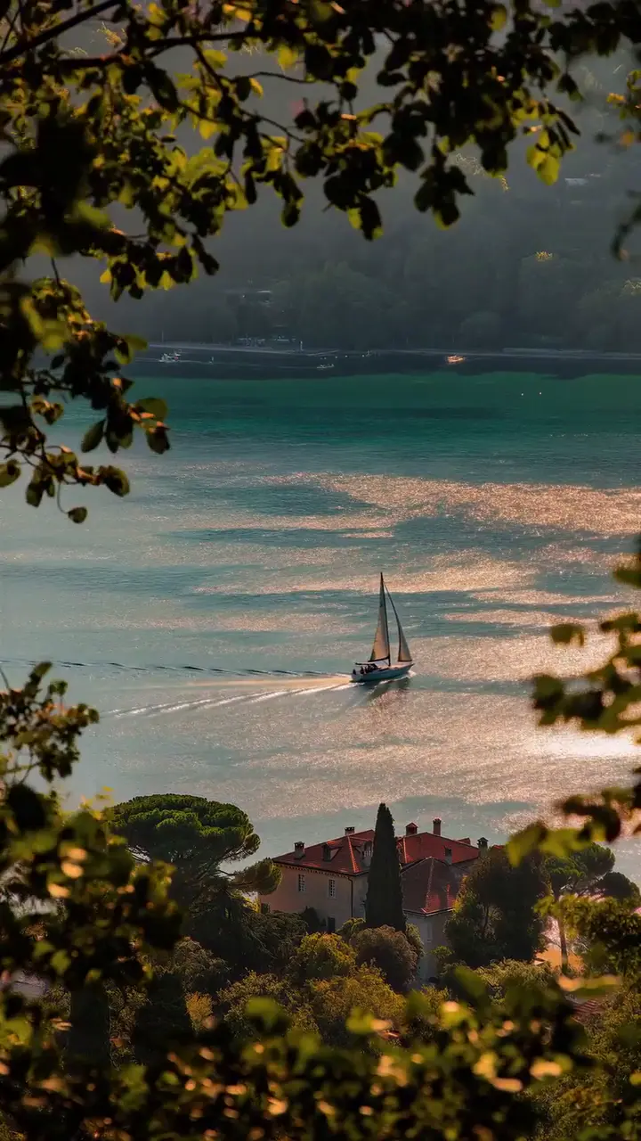 Coastal Sailboat on Shimmering Water Nature Wallpaper